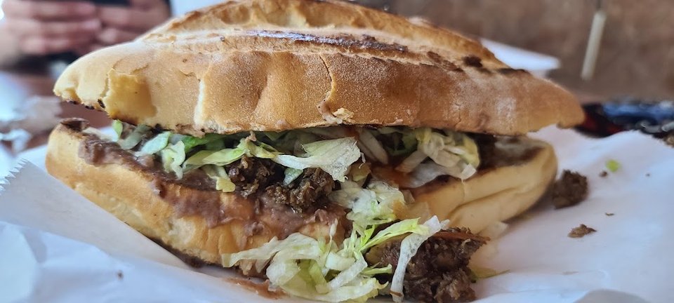 Simple menu listing tortas, sopes, and flan.