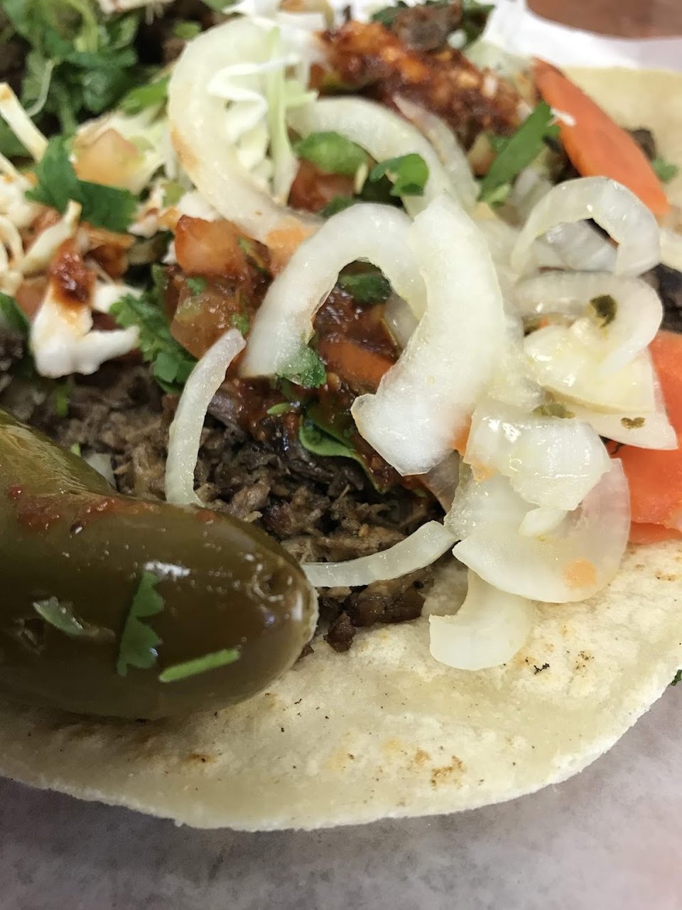 Printed menu with burritos and tacos.